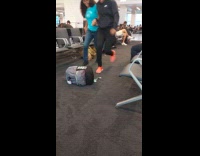 Collab IITW - Two women jump behind bag travel transition inside airport