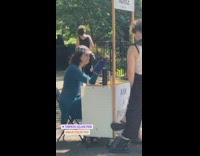 Woman talks with puppet hand in park