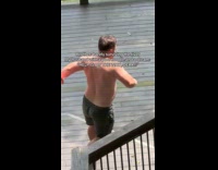 Man with pool noodle run towards river
