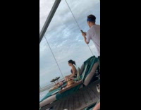 Woman in bikini poses rooftop pool sunbed