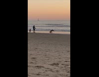 Woman bend over hair flip beach sunset