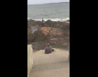 Man jean jacket yellow face mask beach rocks photo shoot