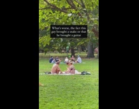 Shirtless guy acoustic guitar snake park grass 