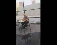 Guy reads newspaper on fire 