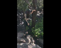 Guy hangs off tree to photograph girl 