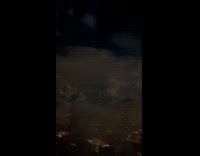 Lightning strike behind dark clouds at flight