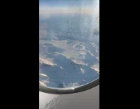 Frozen Greenland mountains view from plane ride
