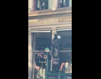 Man stands at digital signage wears costume