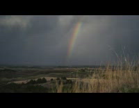 Time lapse of grey clouds and rainbow 