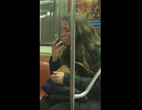 Woman looks closely at herself using a compact mirror on a subway train #BluePointWhatTheL