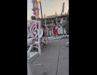 Two girls pose red dress rooftop restaurant 