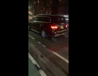 Black suv car on road driving with flat rear tire