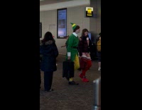 Man wears elf costume walks on airport