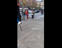 Man pogo sticks on sidewalk