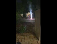 Three people fireworks fountain too close nighttime