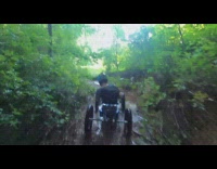 Guy rides electric atv through mud 