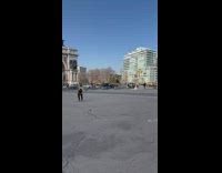 Man stands on bike with basketball on head