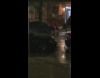 Man wipe his car while raining night