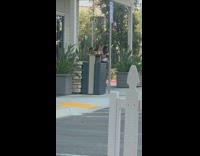 Three girls unsynchronized dance plants white fence