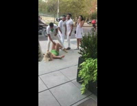 Drunk woman in neon green dress blacks out in front of restaurant and falls on the ground 