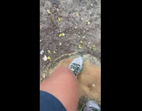 man in black wet suit throwing punches at air at beach
