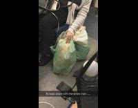 woman eating popcorn from green bag