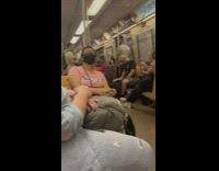 Guy plays clarinet in crowded subway