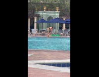 Woman in bikini poses at the pool