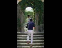 Woman posing stone arc with leaves