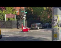 Guy rides small racecar down street