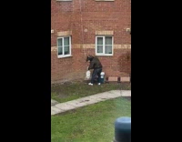 Guy puts items in white bag rope 