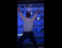 Woman in building across dance on window