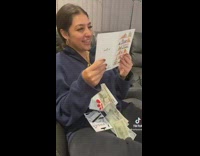 Girl given card cash and cards fall out 