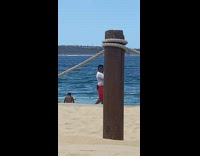 Woman in bikini poses with the lifeguard take pictures