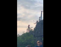 Woman juggles poi balls at mountain top