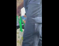 Guy smokes in between train cars