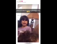 Little girl in purple hits other little girl back of head book