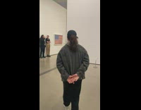 Girl in museum walks by art copies man