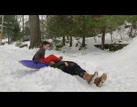 Girl riding sled lands on dads face 