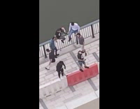 Guy stands orange traffic barrier selfie friends 