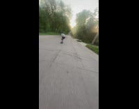 Man rides longboard down the downhill road
