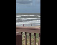 Two women in bikini brisk walk at the beach