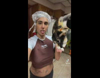 Woman holding cat in palm of hand 