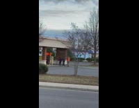 Man in green top music video shoot parking lot