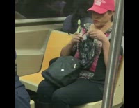Woman red hat brushes her teeth and spits in plastic bag on the train