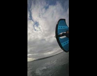 Guy paragliding narrowly misses camera in water