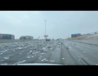 Newspapers fly all over highway from open truck