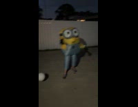 Person in inflatable Minions costume with ball
