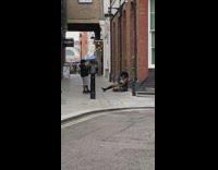 Model vapes for photoshoot in alley 