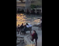 Woman kicks and bends her back near river 